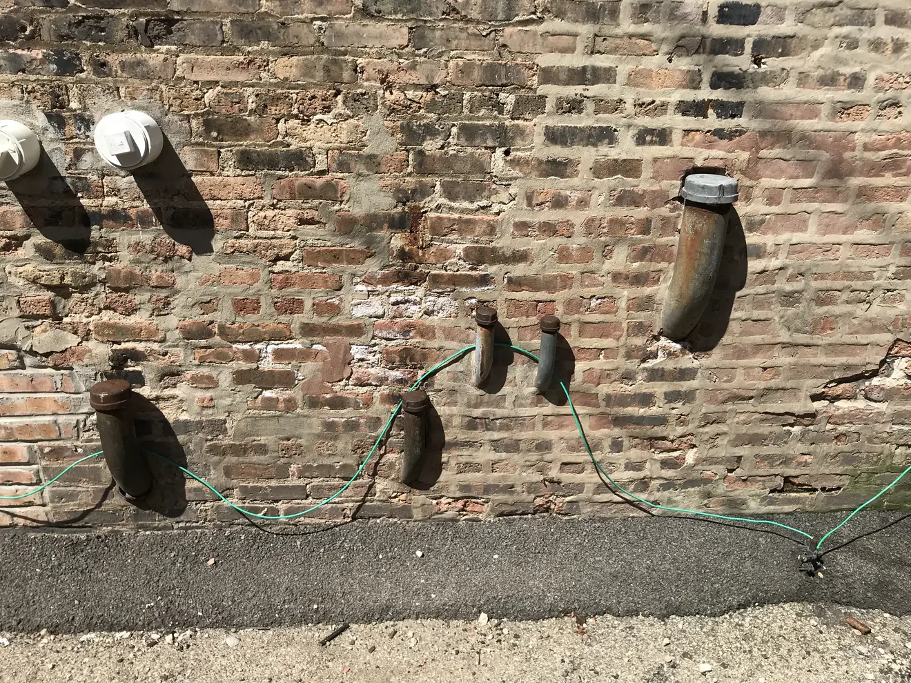 Weathered piping on an older industrial building — legacy infrastructure on a contaminated Michigan property eligible for a Baseline Environmental Assessment